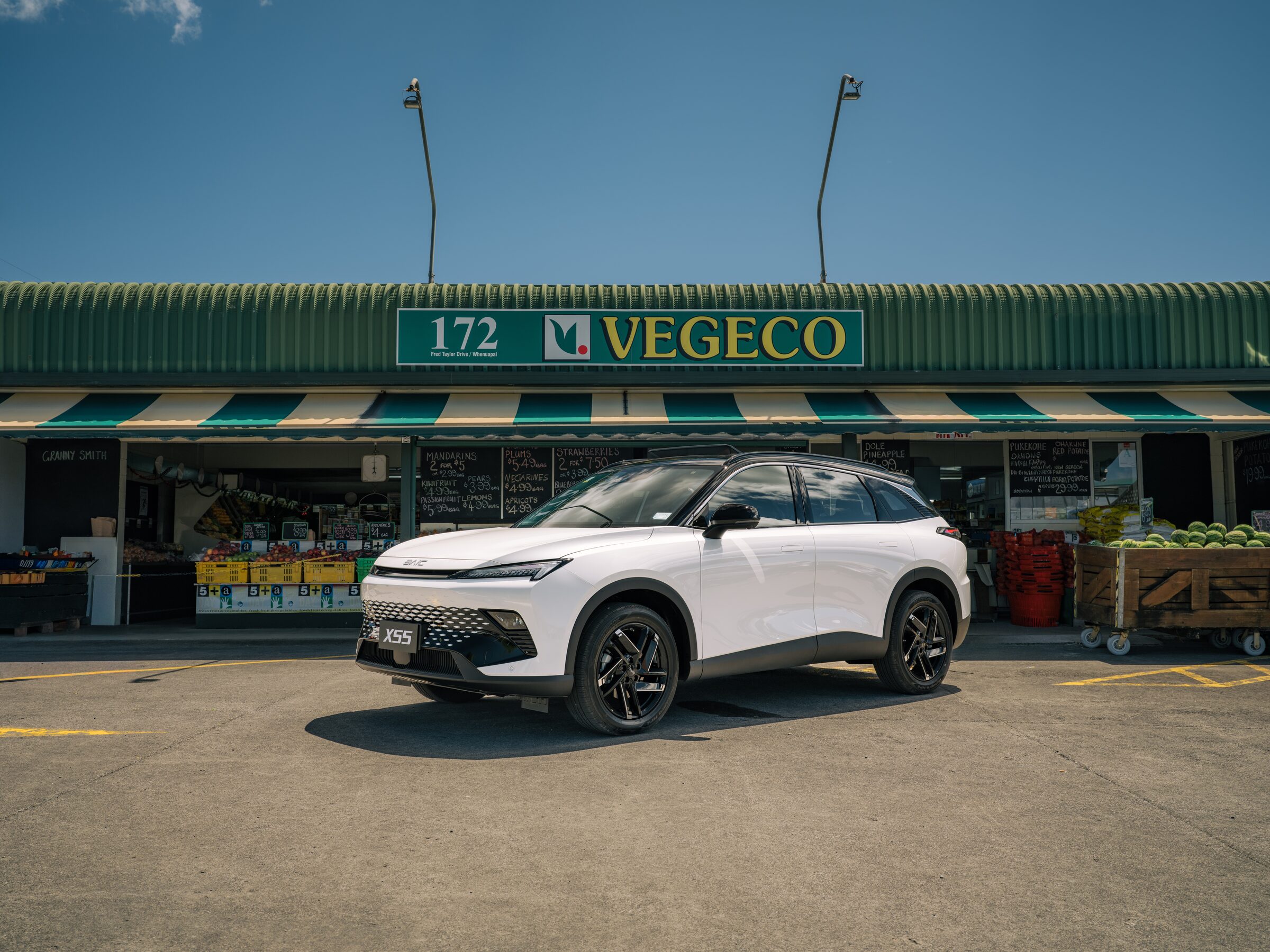 White BAIC X55 outside a market