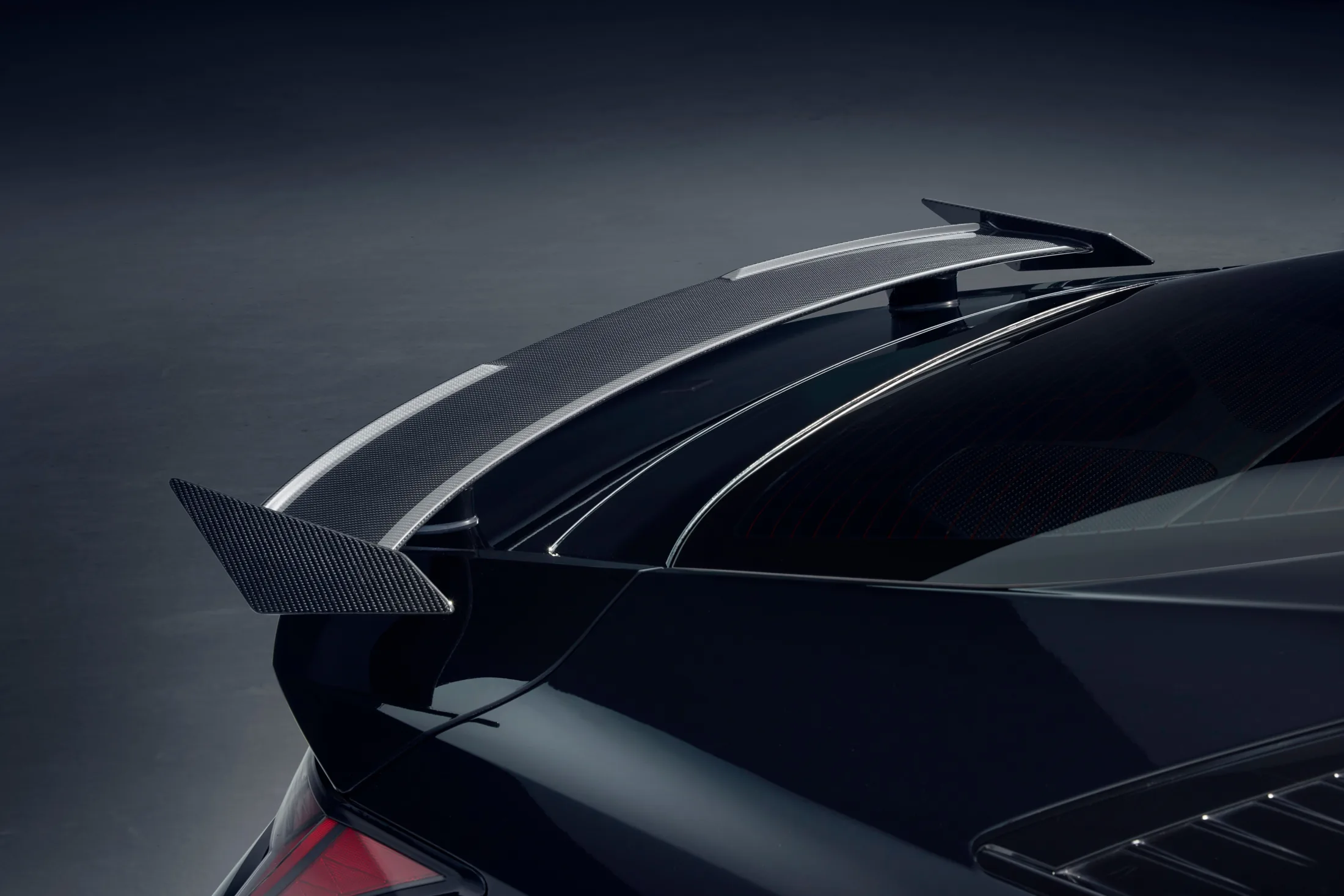 Monochrome Upper carbon-fibre rear spoiler detail.