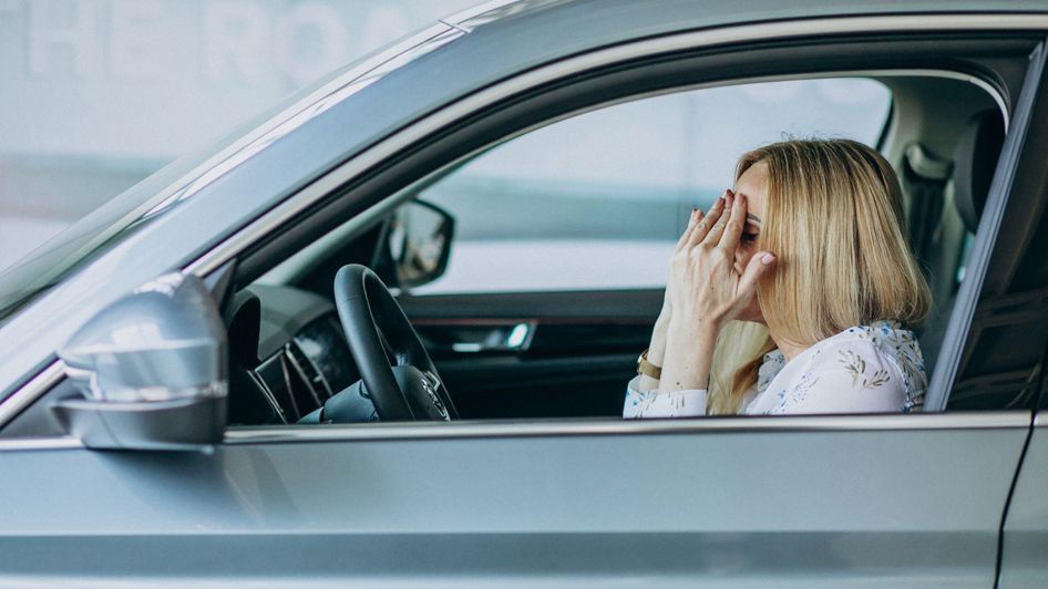 Stressed woman inside car